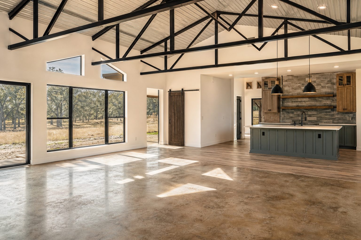 Interior living space of mid-range barndominium in Palo Pinto County showing open-plan design and natural window light.