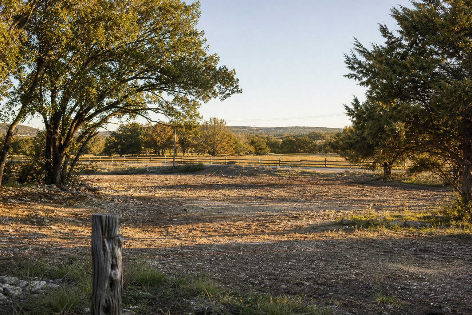 Cleared quarter-acre building lot with specimen oak trees and Texas limestone soil in Bridgeport, Wise County.