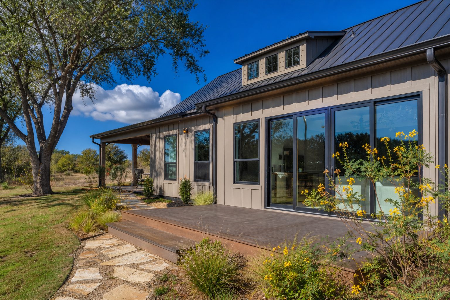 Modern farmhouse new construction with board-and-batten siding and standing seam roof on half-acre lot in southwest Weatherford.