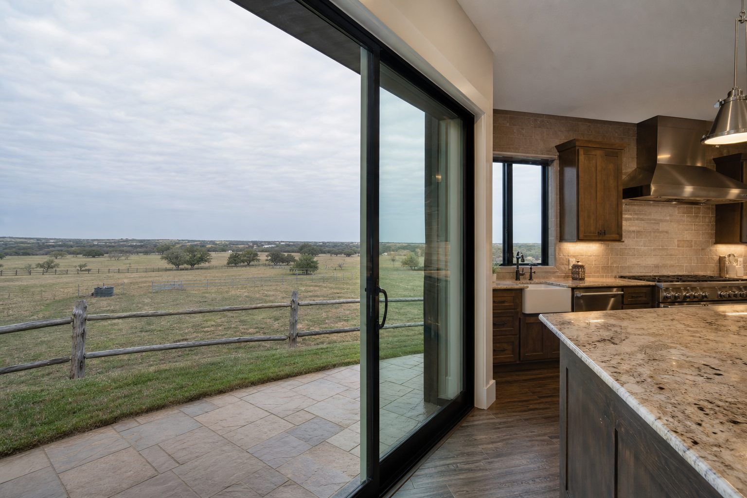 Kitchen interior with ranch views through glass doors across pasture and fence line in central Wise County.