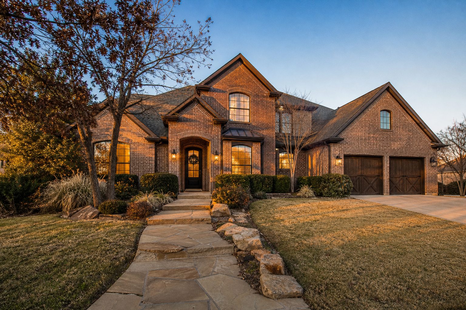 Brick suburban home in Willow Park at golden hour with manicured lawn and mature winter landscaping under clear sky.