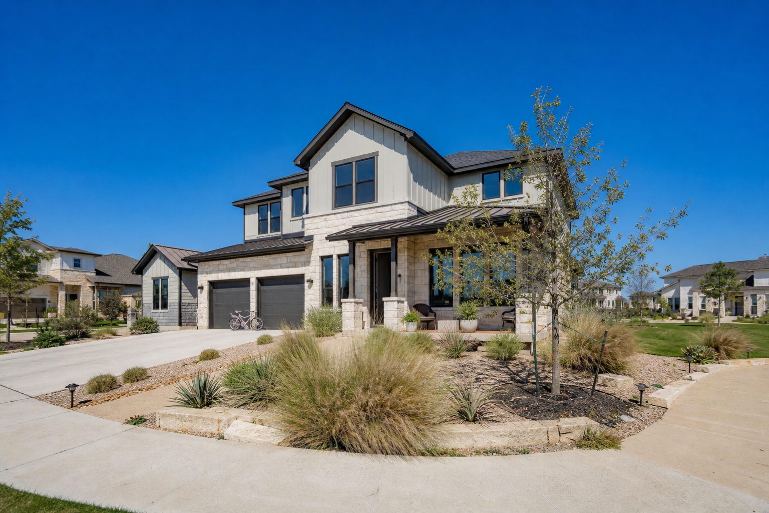 Contemporary two-story family home with native landscaping in Whitestone Ranch neighborhood, midday lighting with clear blue sky.